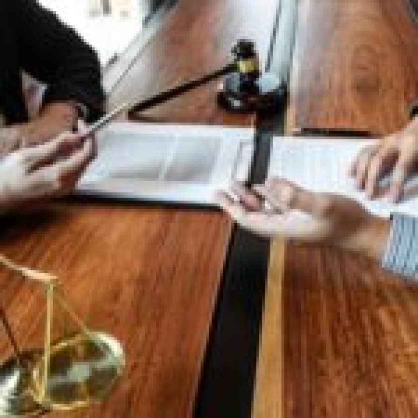 high-angle-view-lawyer-client-discussing-table
